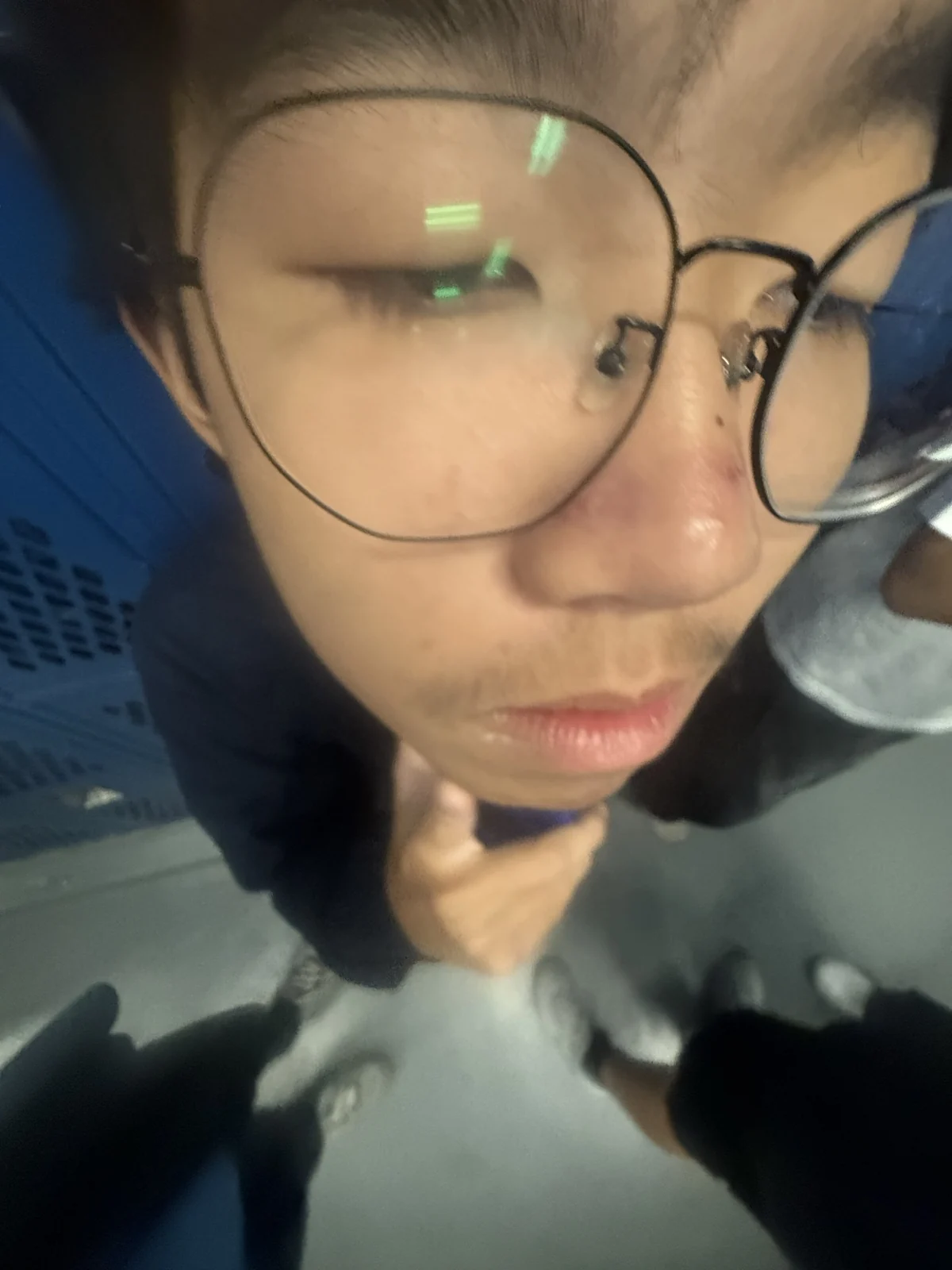A close-up portrait by blue lockers